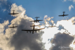 Silhouettes of KA114, Lancaster, two Spitfires and two Hurricanes against a bright sky.