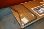 This is an example of the windscreen glass for a fighter/sighter-bomber Mosquito. Note the layers visible at the edges.