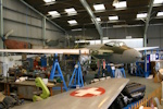 Overall view of TA122 from the front starboard quarter. Note trestles and jacks holding the airframe in flying attitude.